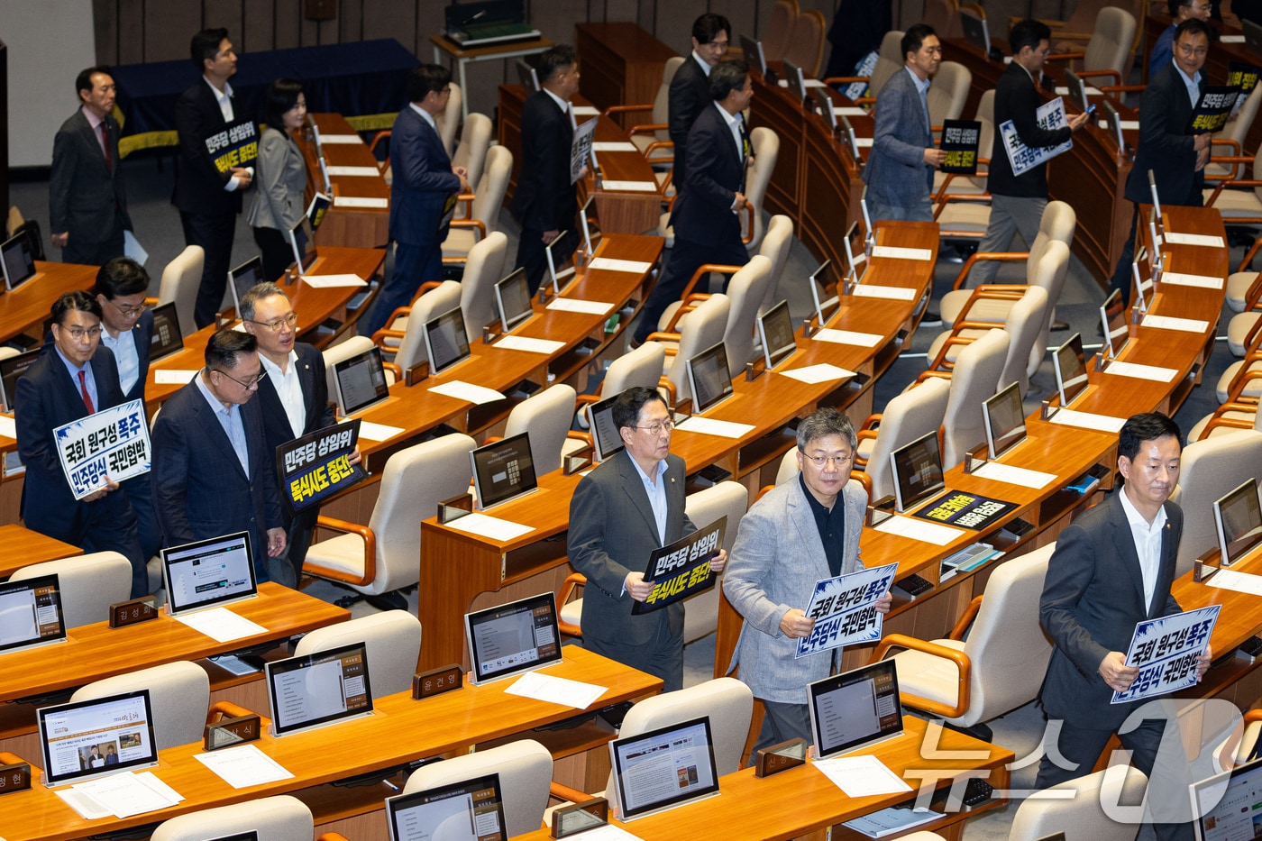 30일 서울 여의도 국회에서 열린 제436회 국회(임시회) 제4차 본회의에서 국민의힘 의원들이 여당 단독 원구성에 반대하는 피켓 시위 중 상임위원장 선거가 시작되자 퇴장하고 있다. 2026.6.30 ⓒ 뉴스1 유승관 기자