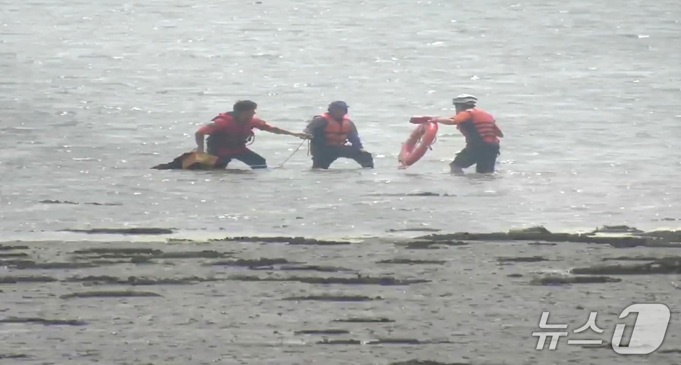 3일 오후 1시 37분께 전북 부안군 진서면 인근 갯벌에서 소방대원들이 밀물에 고립된 A 씨(70대)와 B 씨(50대)를 구조하고 있다.(전북소방본부 제공. 재판매 및 DB금지)