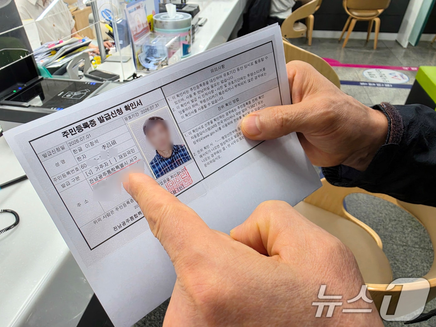 전남광주통합특별시가 출범한 1일 오전 9시 전남광주 서구 금호1동 행정복지센터에서 '1호 주민등록증 발급자'인 이창석 씨(66)가 주민등록증 발급신청 확인서에서 주소를 확인하고 있다.2026.7.1 ⓒ 뉴스1 이수민 기자
