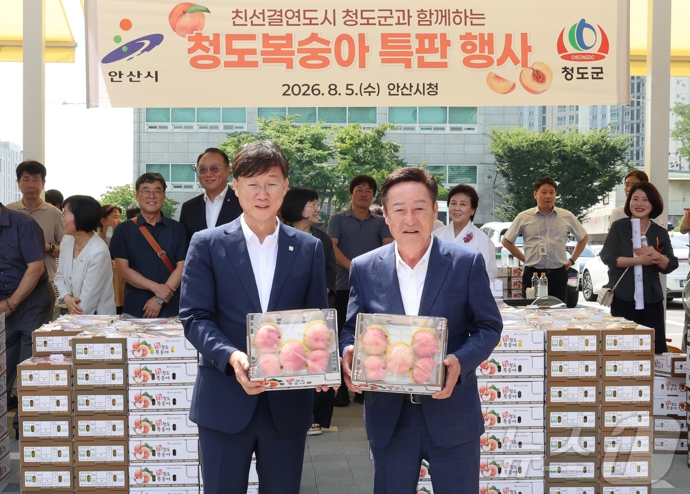 자매도시 경기 안산시에서 청도복숭아 특판행사를 연 박권현 경북 청도군수(오른쪽)가 5일 이민근 안산시장과 청도복숭아를 들고 기념사진을 찍고 있다.(청도군 제공. 재판매 및 DB금지)2026.8.5 ⓒ 뉴스1 정우용 기자